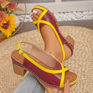 Close-up of color-block maroon and yellow mid-heel peep-toe sandals for summer.