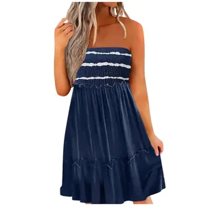 Detailed view of navy blue smocked tube dress featuring white stripes and tiered ruffles