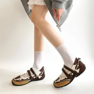 Detail view of brown functional ballet flats with mesh and straps on walking model