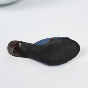 Gedetailleerd onderaanzicht van denim peep-toe slipper met antislip rubberen zool