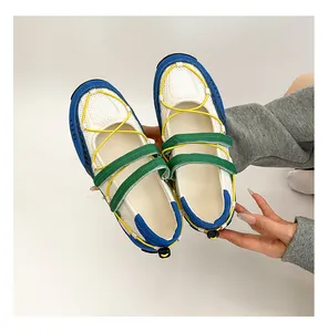 Detailed view of colorful functional ballet sneakers with green straps and yellow laces.
