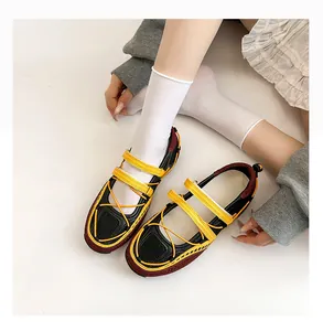 Close-up of functional ballet sneakers featuring yellow straps and mesh design details