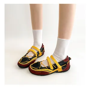 Close-up of functional Mary Jane ballet shoes in burgundy and yellow on white socks.