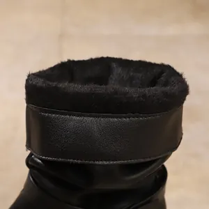 Close-up detail of the warm black faux fur lining inside a stylish women's winter ankle boot