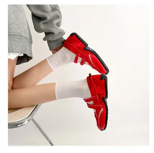 Detailed view of red athletic Mary Jane ballet flats featuring mesh and strap details
