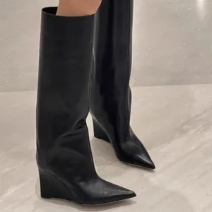 Elegant black pointed-toe wedge tall boots with a wide pant-leg design for women.