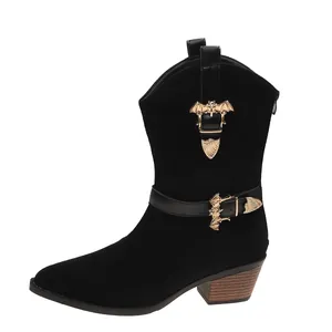 Detailed view of black suede western boots featuring unique gold bat-shaped buckles.