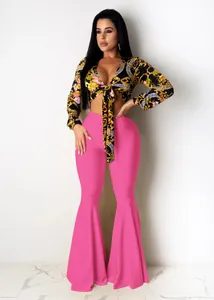 Sexy two-piece set with baroque print tie-front top and hot pink flared pants for nightclub
