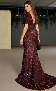 Back view of an elegant burgundy sequined maxi evening gown with V-neck and train detail