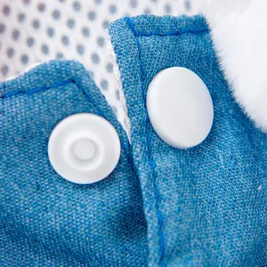 Close-up detail of white snap buttons on blue denim pet princess dress with fur trim