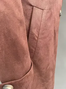 Close-up detail of western faux suede long trench coat pocket and fabric texture