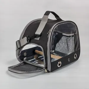 Portable foldable bird carrier bag featuring interior wooden perch and metal tray view