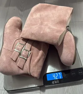 Detailed view of pink suede slouchy high boots with buckles weighing 427g on a scale
