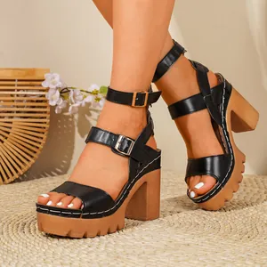 Black platform chunky heel sandals featuring ankle straps and white stitching details