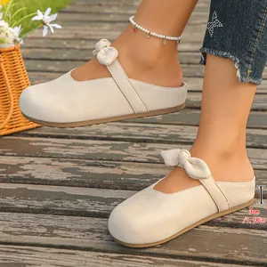Detailed side view of women's beige bow mules featuring a 3cm height increasing sole.