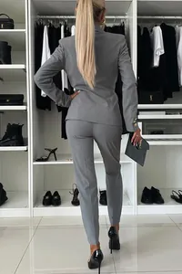 Elegant grey women's two-piece professional slim fit blazer and trousers suit set.