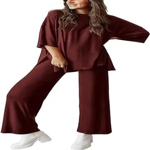 Full view of women's burgundy two-piece loose top and wide-leg trousers set