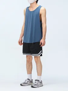 Men's black mesh athletic shorts with white hem stripes shown on a model in a full look