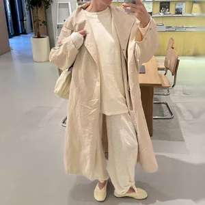 Chic full-body view of light apricot oversized trench coat with large lapels for autumn