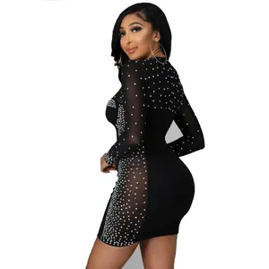 Detail view of black bodycon dress with sheer mesh panels and sparkling rhinestones