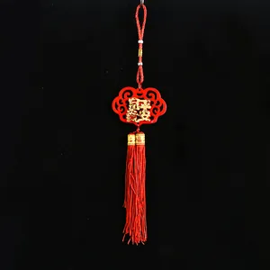 Traditional red Chinese New Year hanging decoration with gold lucky character and tassel
