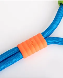 Macro detail of blue braided dog leash featuring an orange textured paw print connector