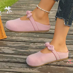 Close-up of pink suede bow mules showing the 3cm heel height for a comfortable lift