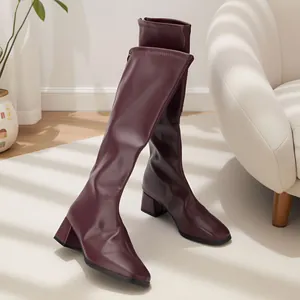 Side view of burgundy high-barrel knight boots with square toe and chunky heel detail