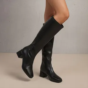 Side view of elegant black square toe knee-high boots with a comfortable block heel
