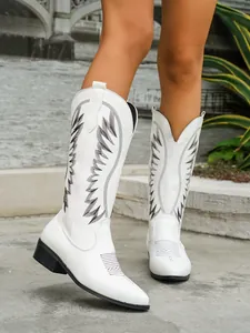 Detailed view of white Western boots for women with black embroidery and pointed toe