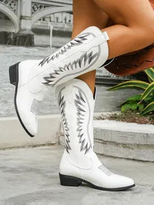 Detail of white women's western tall boots with black embroidery and pointed toe
