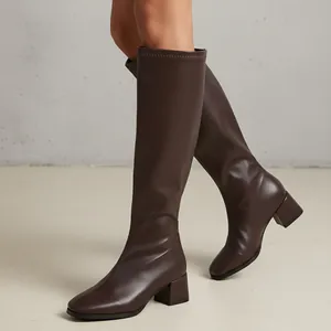 Detailed side view of brown knee-high knight boots with square toe and block heel.
