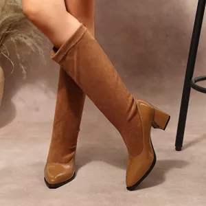 Detail of vintage spliced suede and patent leather pointed toe chunky heel boots