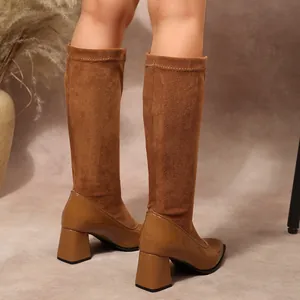 Close-up detail of French vintage chunky heel boots featuring suede and patent patchwork