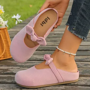 Pink suede platform mule sandals with charming bow detail for casual summer wear
