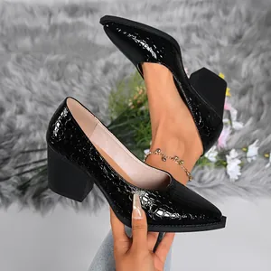 Detailed view of black crocodile embossed block heel pumps featuring a pointed toe design