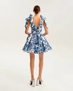 Detailed back view of a blue floral organza mini dress with bow shoulders and lace-up back