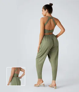 Detailed back view of olive green halter neck jumpsuit with sexy twist knot design