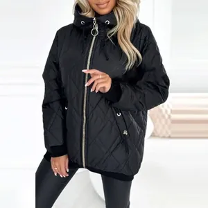 Woman wearing black quilted hooded jacket with diamond pattern and ring zipper detail