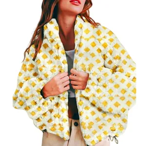 Detail view of yellow diamond pattern fleece jacket for women