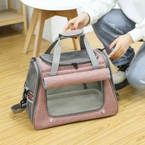 Breathable pink pet carrier bag for cats featuring mesh windows and adjustable strap