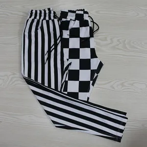 Detail view of the black and white striped and checkered patterns on sport pants