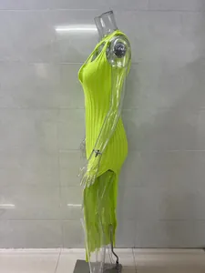 Side view of neon yellow ribbed knit dress with high side slit on transparent mannequin