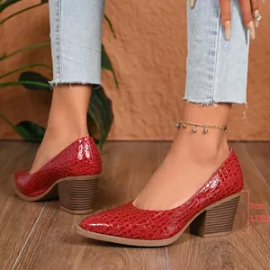 Detailed side view of red crocodile textured pointed toe pumps with a 7cm block heel