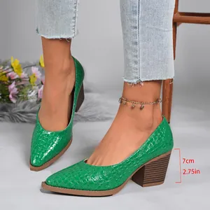 Detailed view of green crocodile pattern block heel pumps with 7cm heel height