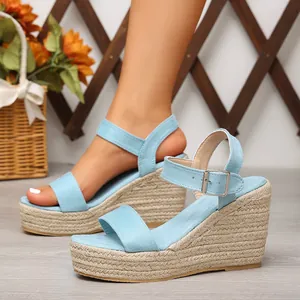 Détail de sandales compensées bleues avec semelle en corde et boucle de fermeture réglable