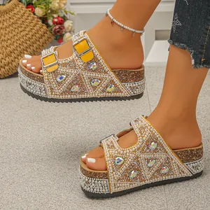 Detailed view of yellow cork platform sandals featuring pearls and teardrop rhinestones