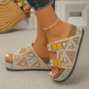 Detailed view of sparkling rhinestones and pearl embellishments on cork platform slides