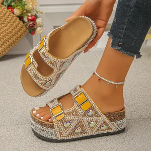Close-up detail of yellow platform sandals decorated with pearls and colorful rhinestones