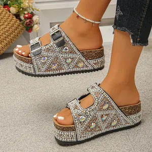 Detailed view of women's platform slides adorned with white pearls and crystals.
